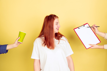 Image showing Caucasian young woman\'s portrait on yellow background, too much tasks