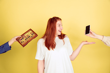 Image showing Caucasian young woman\'s portrait on yellow background, too much tasks