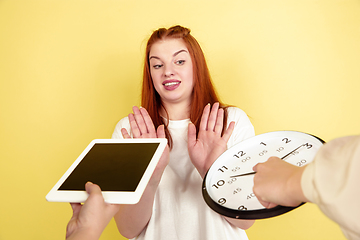 Image showing Caucasian young woman\'s portrait on yellow background, too much tasks