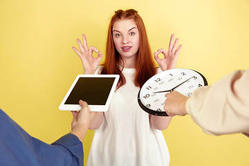 Image showing Caucasian young woman\'s portrait on yellow background, too much tasks