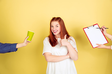 Image showing Caucasian young woman\'s portrait on yellow background, too much tasks