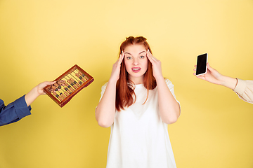 Image showing Caucasian young woman\'s portrait on yellow background, too much tasks