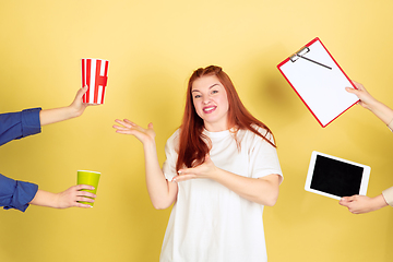 Image showing Caucasian young woman\'s portrait on yellow background, too much tasks