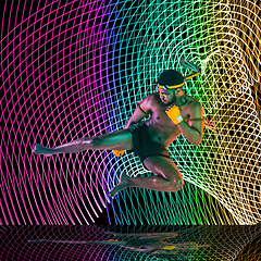 Image showing Creative sport and neon waves on dark neon lighted line background