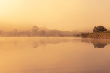 Image showing orange light of sunset over the lake