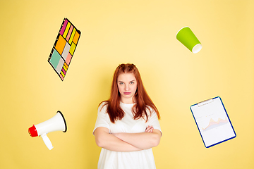 Image showing Caucasian young woman\'s portrait on yellow background, too much tasks