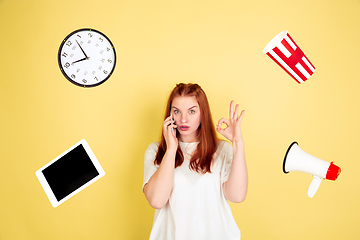 Image showing Caucasian young woman\'s portrait on yellow background, too much tasks