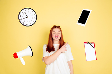 Image showing Caucasian young woman\'s portrait on yellow background, too much tasks