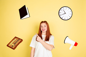 Image showing Caucasian young woman\'s portrait on yellow background, too much tasks