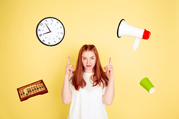 Image showing Caucasian young woman\'s portrait on yellow background, too much tasks