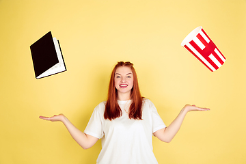 Image showing Caucasian young woman\'s portrait on yellow background, too much tasks