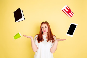 Image showing Caucasian young woman\'s portrait on yellow background, too much tasks