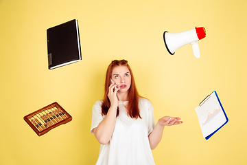 Image showing Caucasian young woman\'s portrait on yellow background, too much tasks