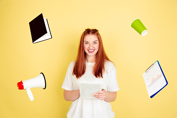 Image showing Caucasian young woman\'s portrait on yellow background, too much tasks