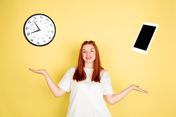 Image showing Caucasian young woman\'s portrait on yellow background, too much tasks