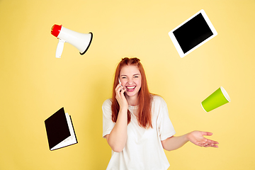 Image showing Caucasian young woman\'s portrait on yellow background, too much tasks