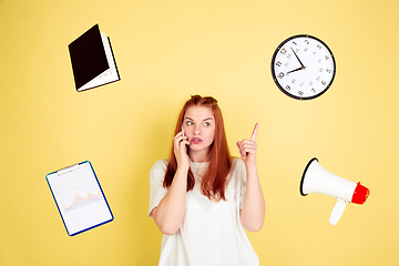 Image showing Caucasian young woman\'s portrait on yellow background, too much tasks