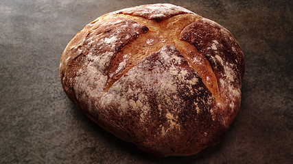 Image showing Freshly baked natural bread is on the kitchen table.