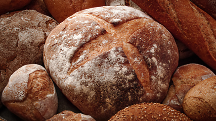 Image showing Freshly baked natural bread is on the kitchen table.