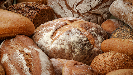 Image showing Freshly baked natural bread is on the kitchen table.