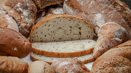 Image showing Freshly baked natural bread is on the kitchen table.