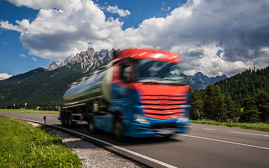 Image showing Fuel truck rushes down the highway in the background the Alps. T