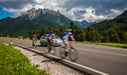 Image showing Cyclists riding a bicycle on the road in the background the Dolo