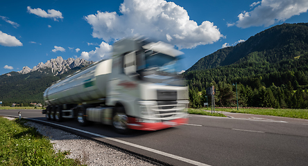 Image showing Fuel truck rushes down the highway in the background the Alps. T