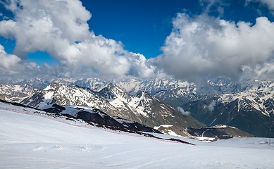 Image showing Mountain clouds over beautiful snow-capped peaks of mountains an