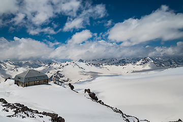 Image showing Mountain clouds over beautiful snow-capped peaks of mountains an