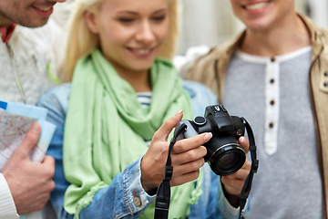 Image showing close up of smiling friends with digital camera