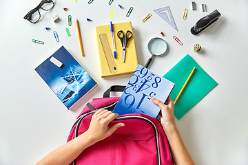 Image showing hands with backpack, books and school supplies