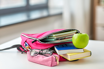 Image showing backpack, apple and school supplies on table