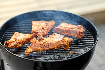 Image showing close up of barbecue meat roasting on grill