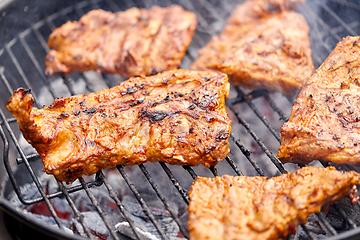 Image showing close up of barbecue meat roasting on grill