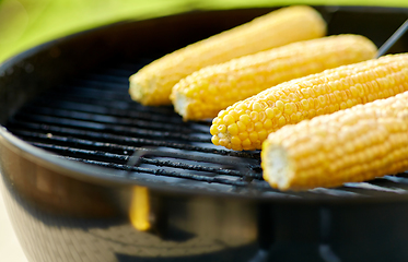 Image showing close up of corn roasting on grill outdoors