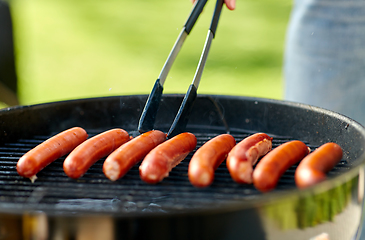 Image showing meat sausages roasting on hot brazier grill