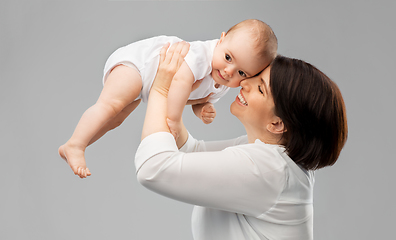 Image showing happy middle-aged mother with little baby daughter