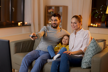 Image showing happy family watching tv at home at night