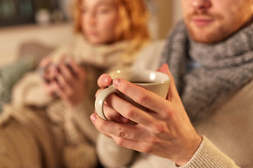 Image showing close up of sick young couple drinking tea at home