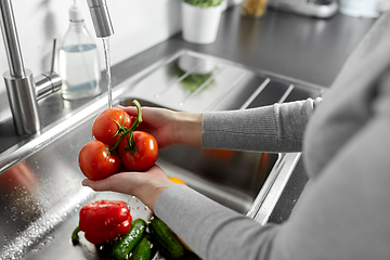 Image showing close up of woman washing vegetables in kitchen