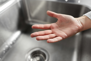 Image showing close up of clean woman's hand over kitchen sink