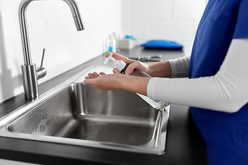 Image showing doctor or nurse washing hands with liquid soap