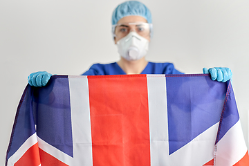 Image showing doctor in goggles and mask holding flag of america