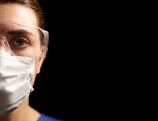 Image showing female doctor or nurse in goggles and face mask