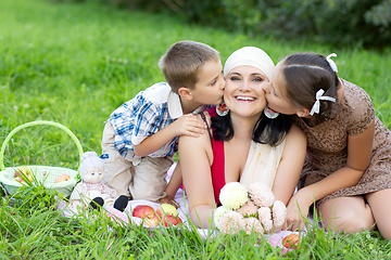 Image showing mother with two kids having picnic outdoors