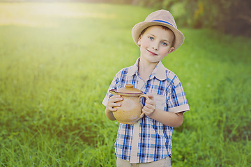 Image showing handsome little boy with jug