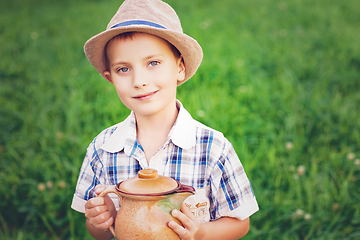 Image showing handsome little boy with jug