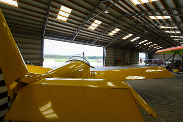 Image showing outdoor shot of small plane standing in shed