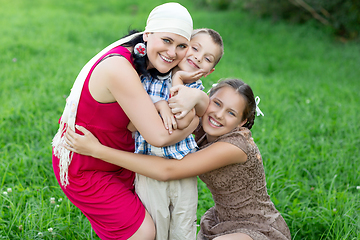 Image showing mother with two kids having picnic outdoors